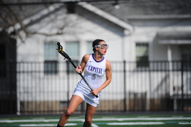 Kara Hines swinging a lacrosse stick