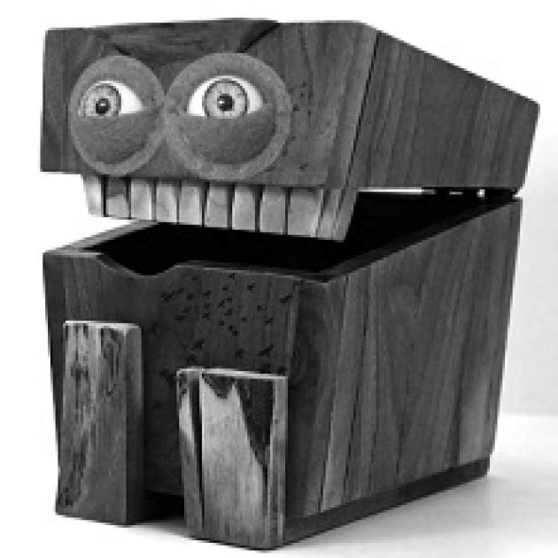 Big box with lid open and two eyes and teeth like a face