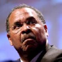 Close up of black man's face with wire rimmed glasses, a moustache and a worried or scared look as he looks up