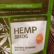 Green bag with white background and words Hemp Seeds and pictures of five leaf plants