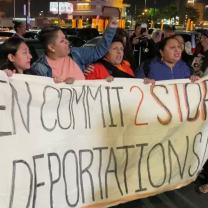 Immigrants holding a banner