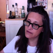 Woman with brown hair and glasses