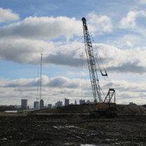 Crane over property with skyline in background