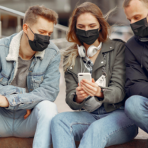 Three young people wearing black face masks